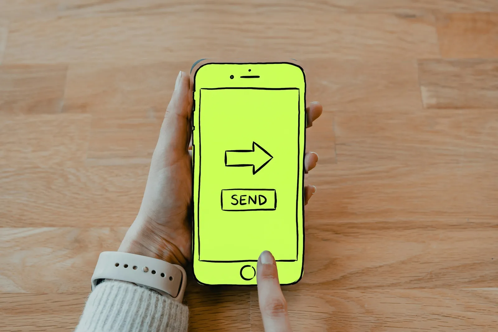 A hand holding a phone with a money transfer screen, the phone drawn in lime ink
