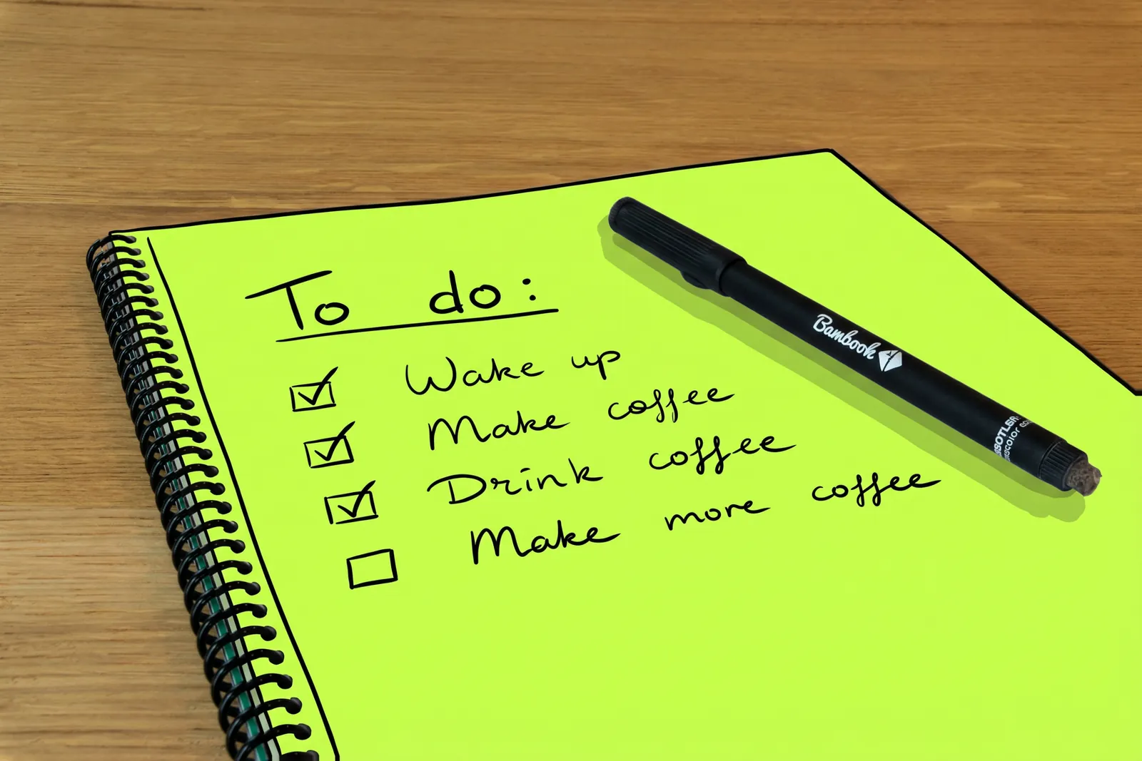 A to-do list notepad with ticked boxes and a pen, the notepad drawn in lime ink